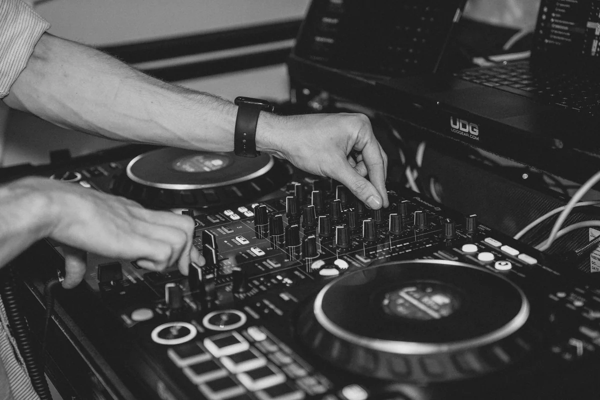 Jannik Trenz mixing music, with his hands on the DJ controller